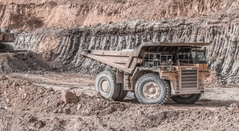 Loadscan solutions in action measuring haul truck loads in a quarry with a large dump truck operating on a mining site.